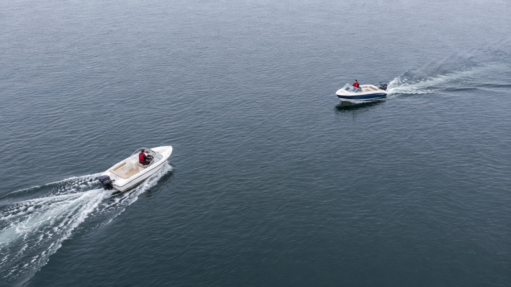 Two boats operating on open water