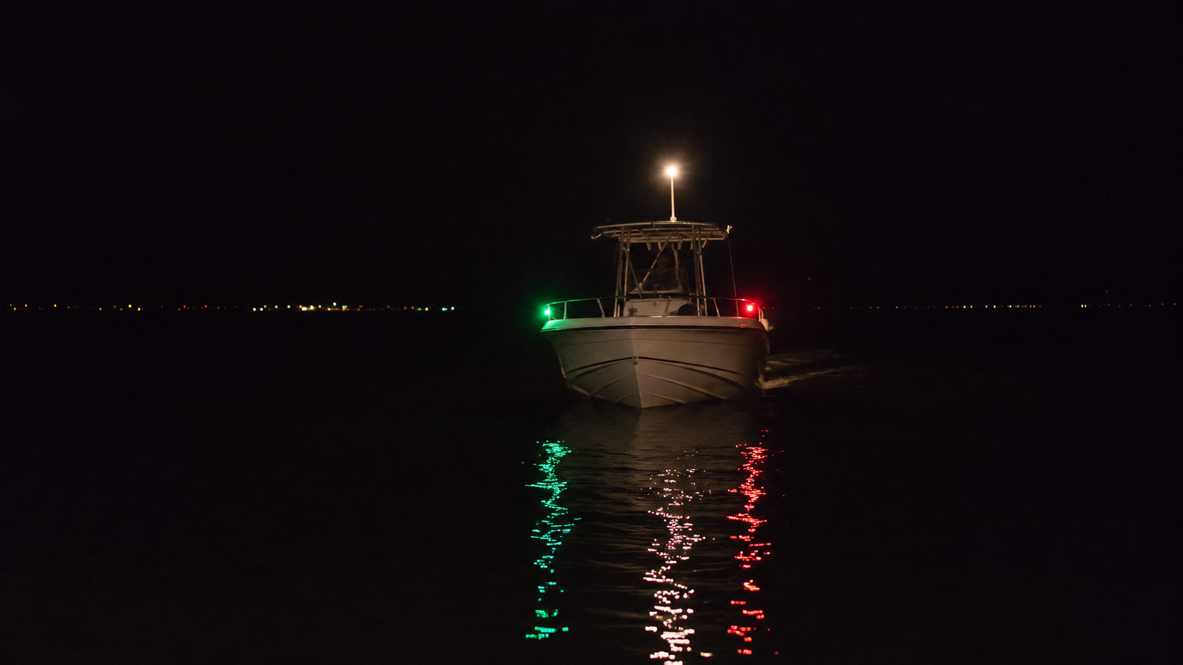 Power-driven vessel displaying navigation lights at night